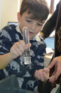 A child turns over a test tube, and no water comes out! Science: like magic, but better.