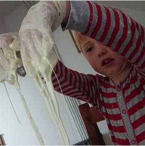 Boy with slime dripping from fingers.